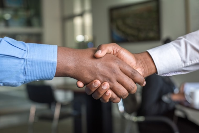 Advisor and client shaking hands after a successful consultation